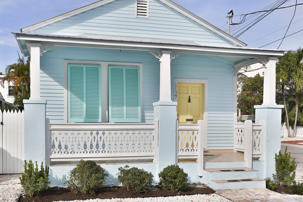 Beautifully painted in Key West colors, the quintessential conch cottage at 1127 Packer Street radiates captivating curb appeal.
